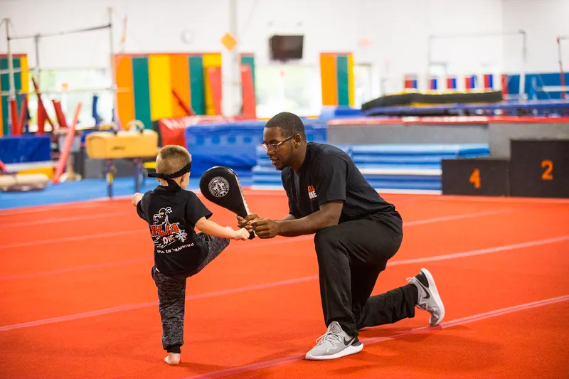 A coach works one-on-one with a Lil' Ninja