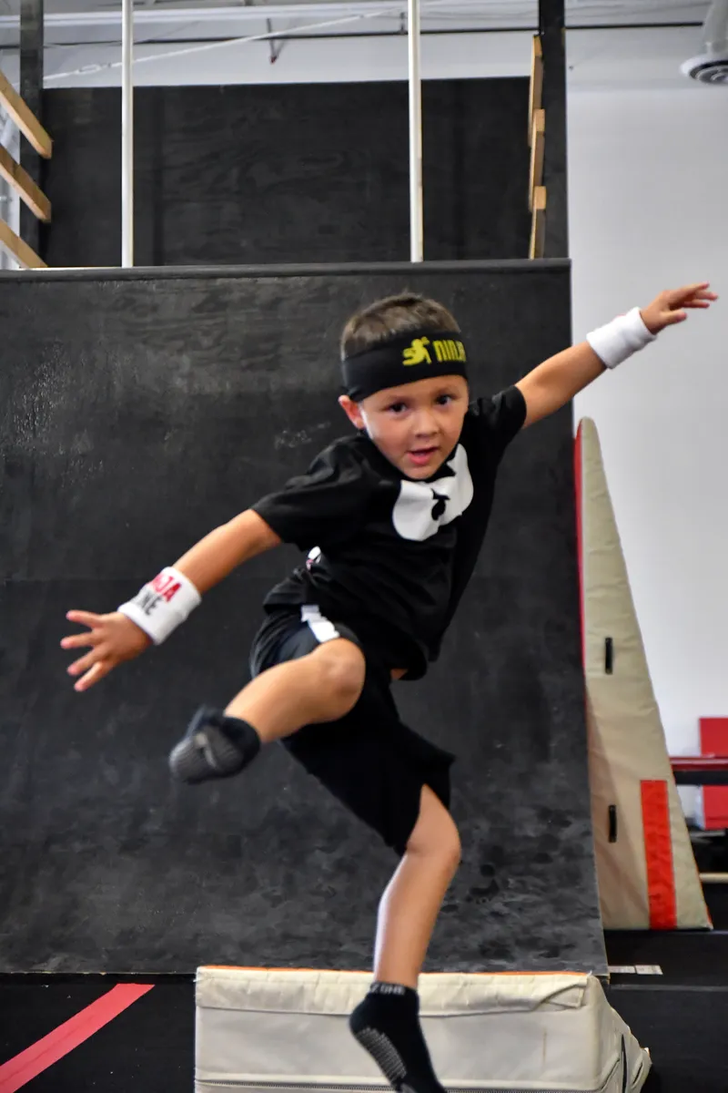 A ninja mid-jump in the gym